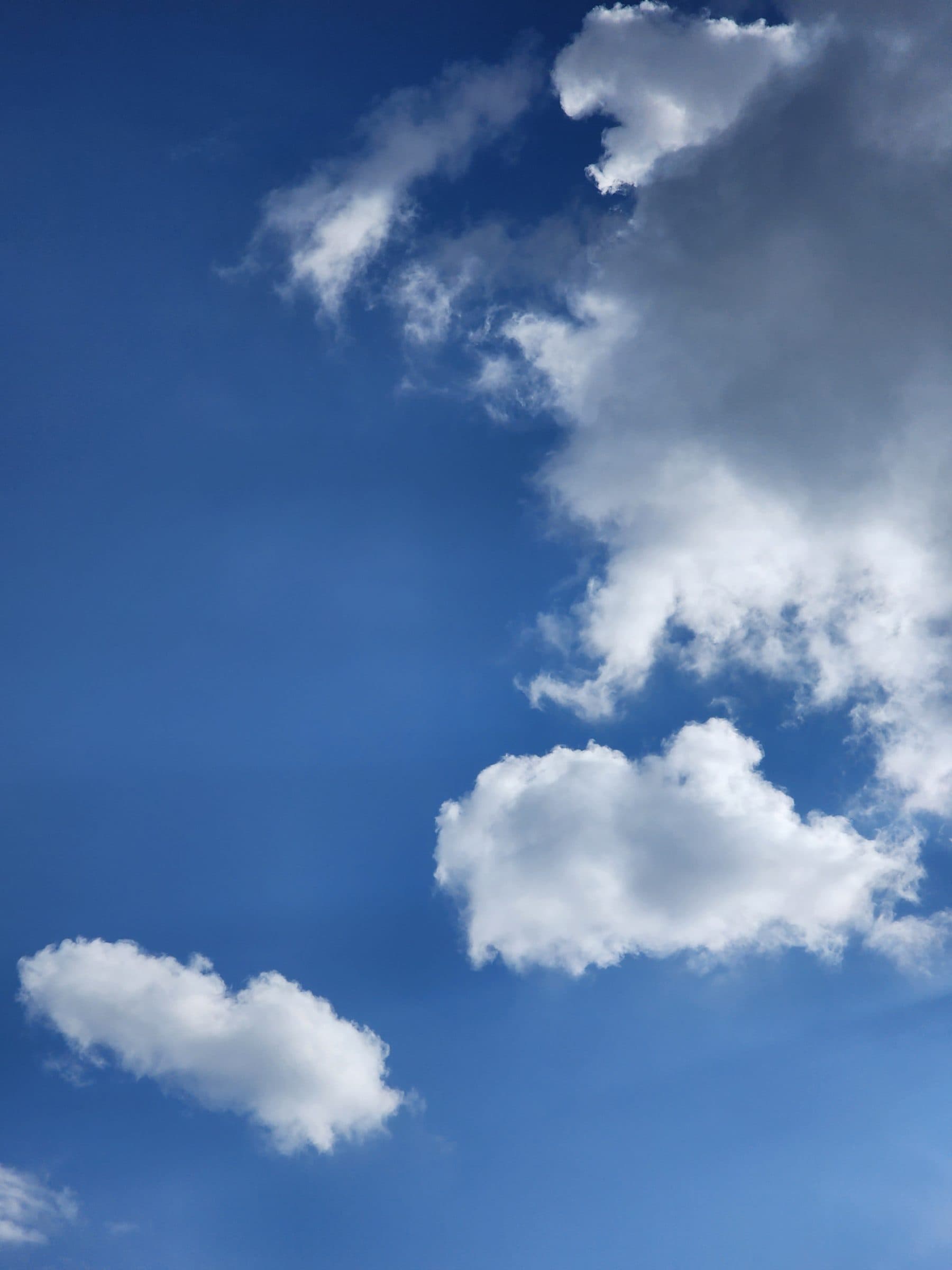 Bright blue sky filled with scattered white wispy clouds