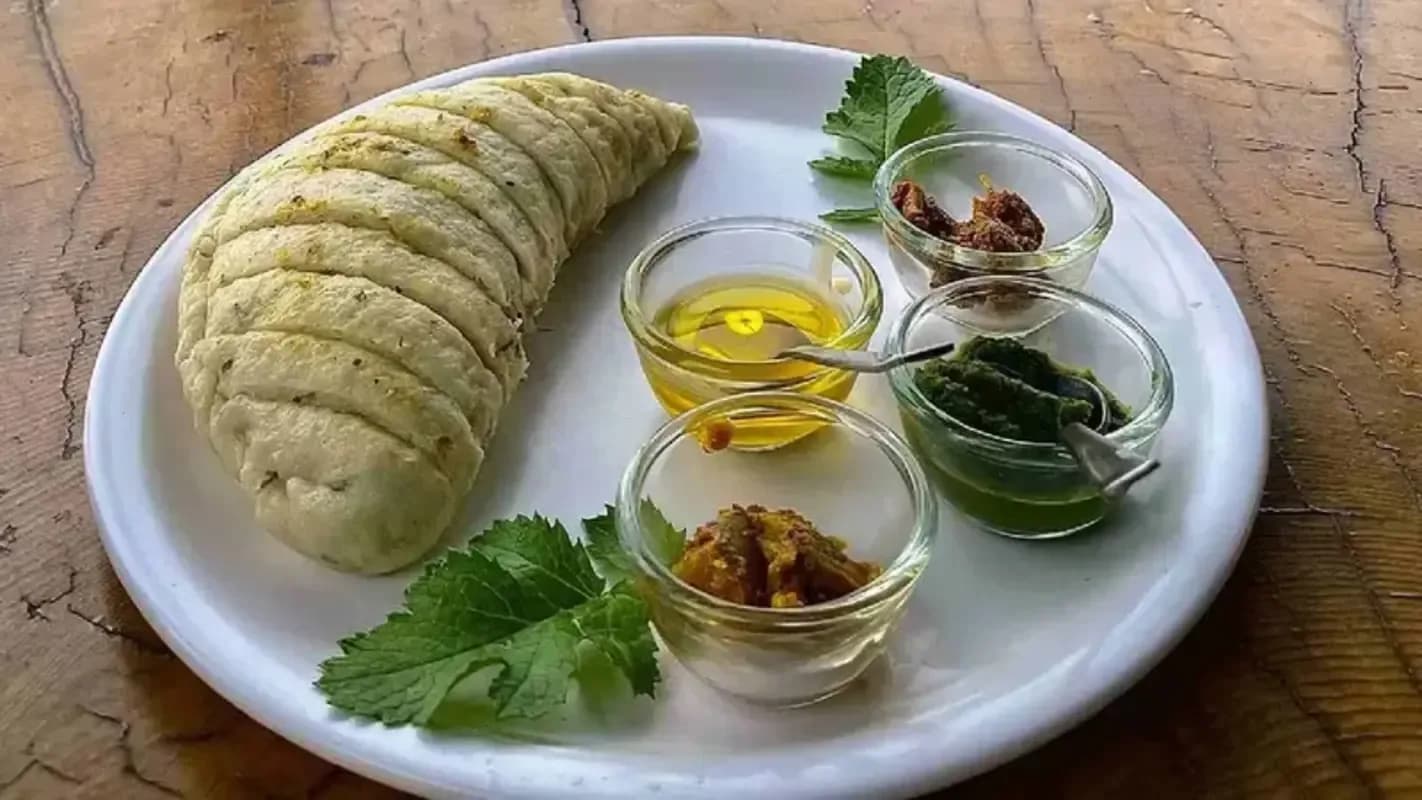 Flatbread, oil, spices, and herbs arranged on a wooden board