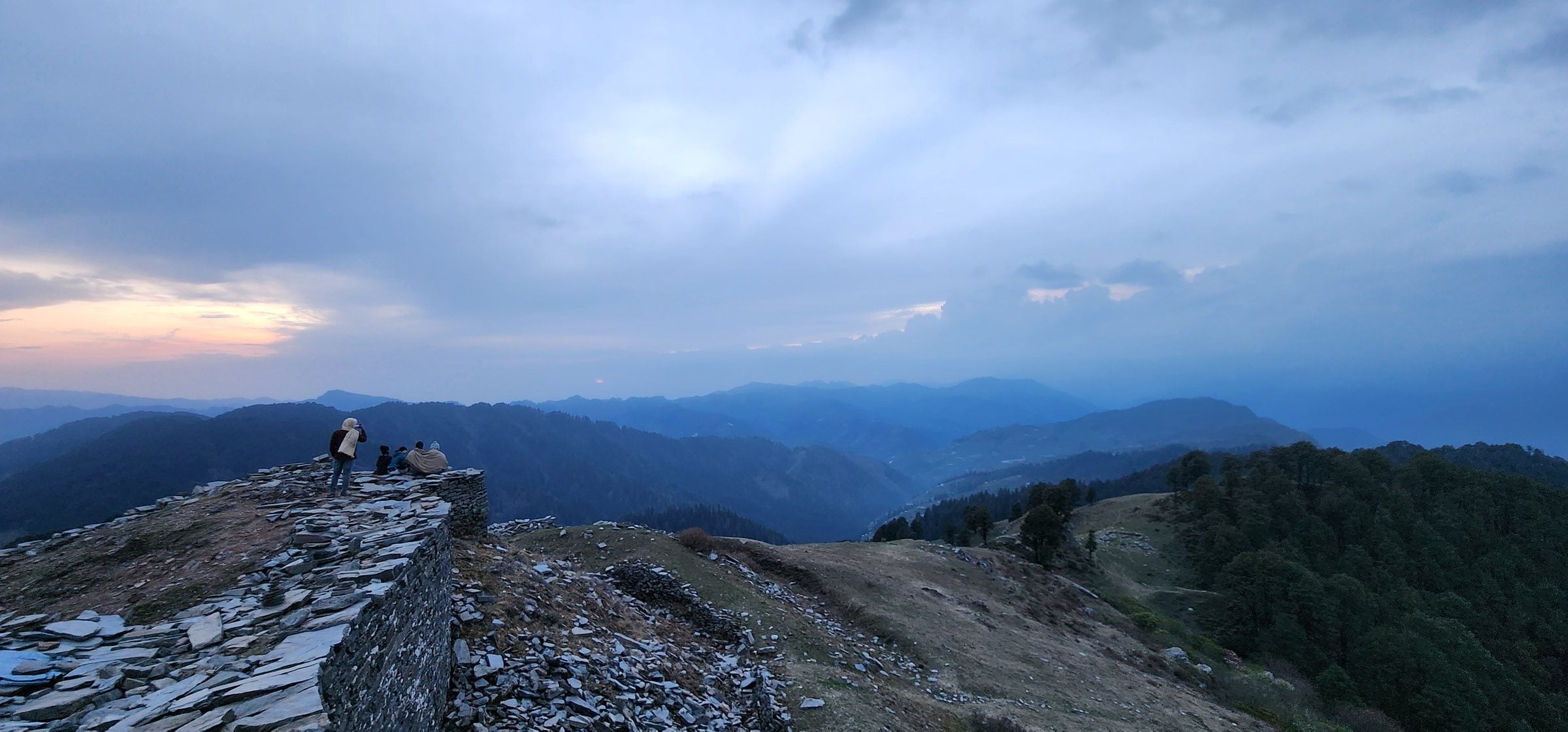 Expansive view of rolling, misty mountains and valleys in Jibhi.