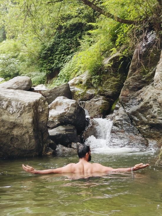 A traveler enjoying a peaceful water dipping session