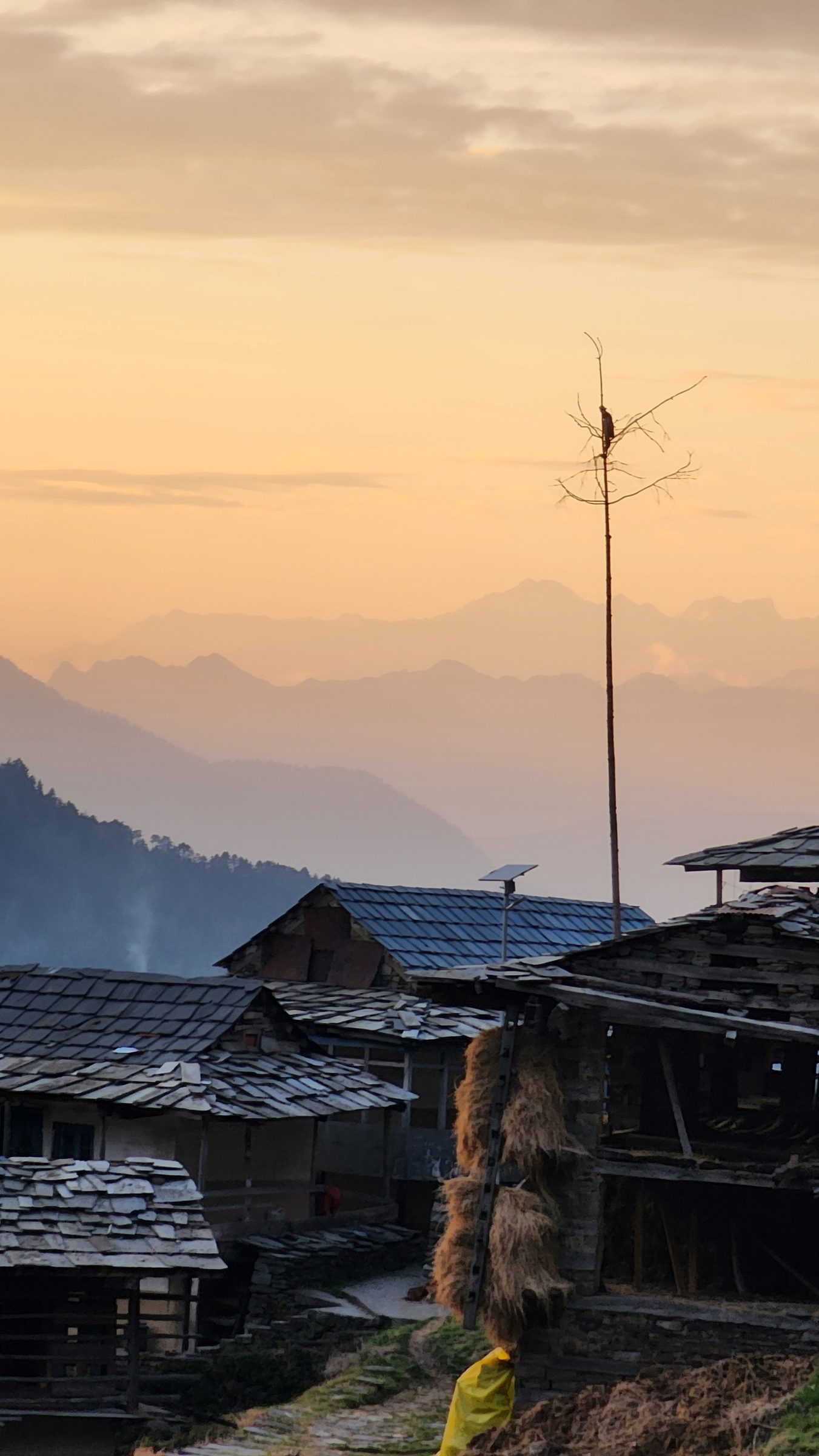 View of rustic wooden roofs and dry grass in mountainous terrain